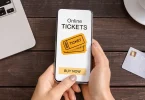 Someone buying tickets on their phone